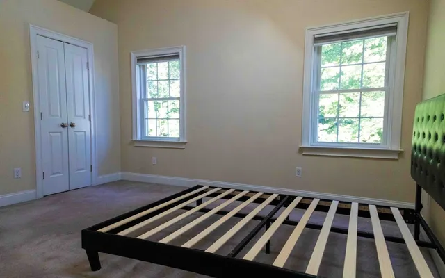 a view of a room with wooden floor and windows