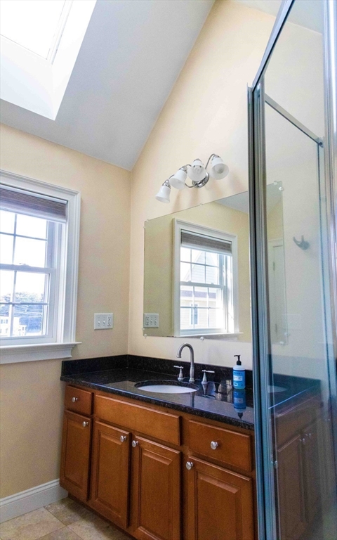 171 North Main Street, Unit 171 Natick, MA 01760 - Photo 13 of 19 a kitchen with granite countertop a sink and a window