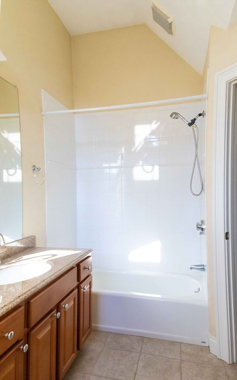 171 North Main Street, Unit 171 Natick, MA 01760 - Photo 17 of 19 a bathroom with a granite countertop sink a mirror and a shower