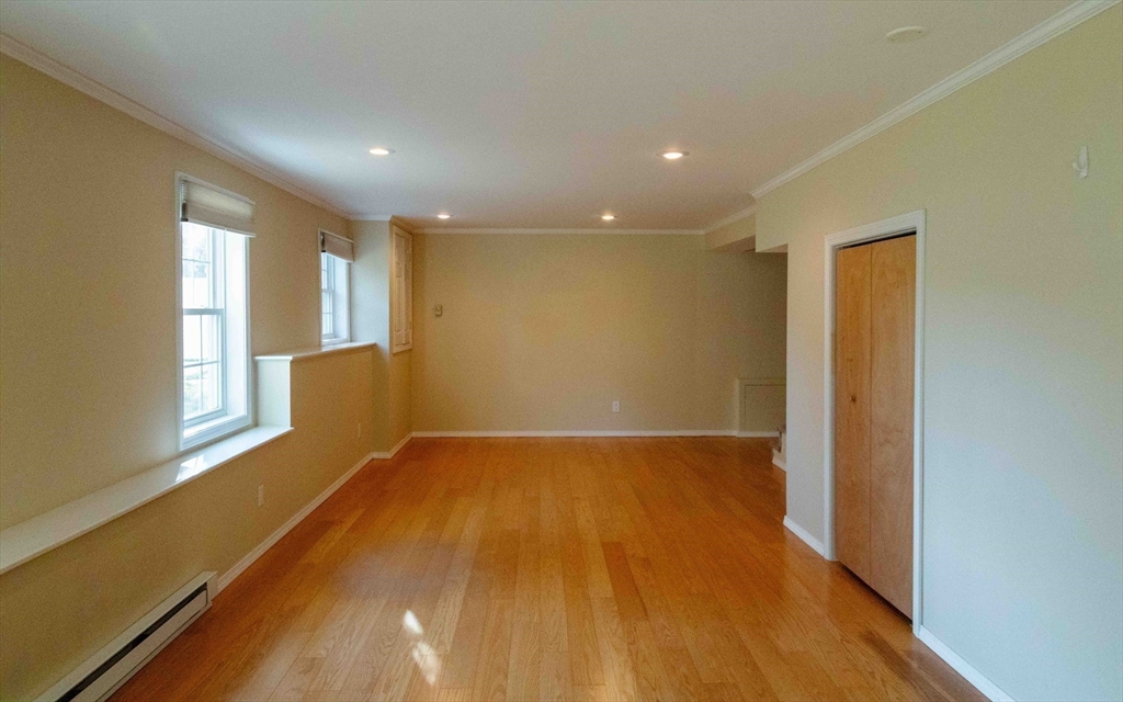 171 North Main Street, Unit 171 Natick, MA 01760 - Photo 8 of 19 a view of an empty room with wooden floor and a window