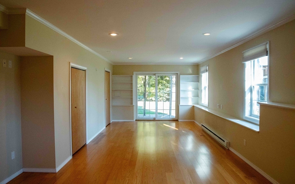 171 North Main Street, Unit 171 Natick, MA 01760 - Photo 9 of 19 a view of empty room with wooden floor and fan