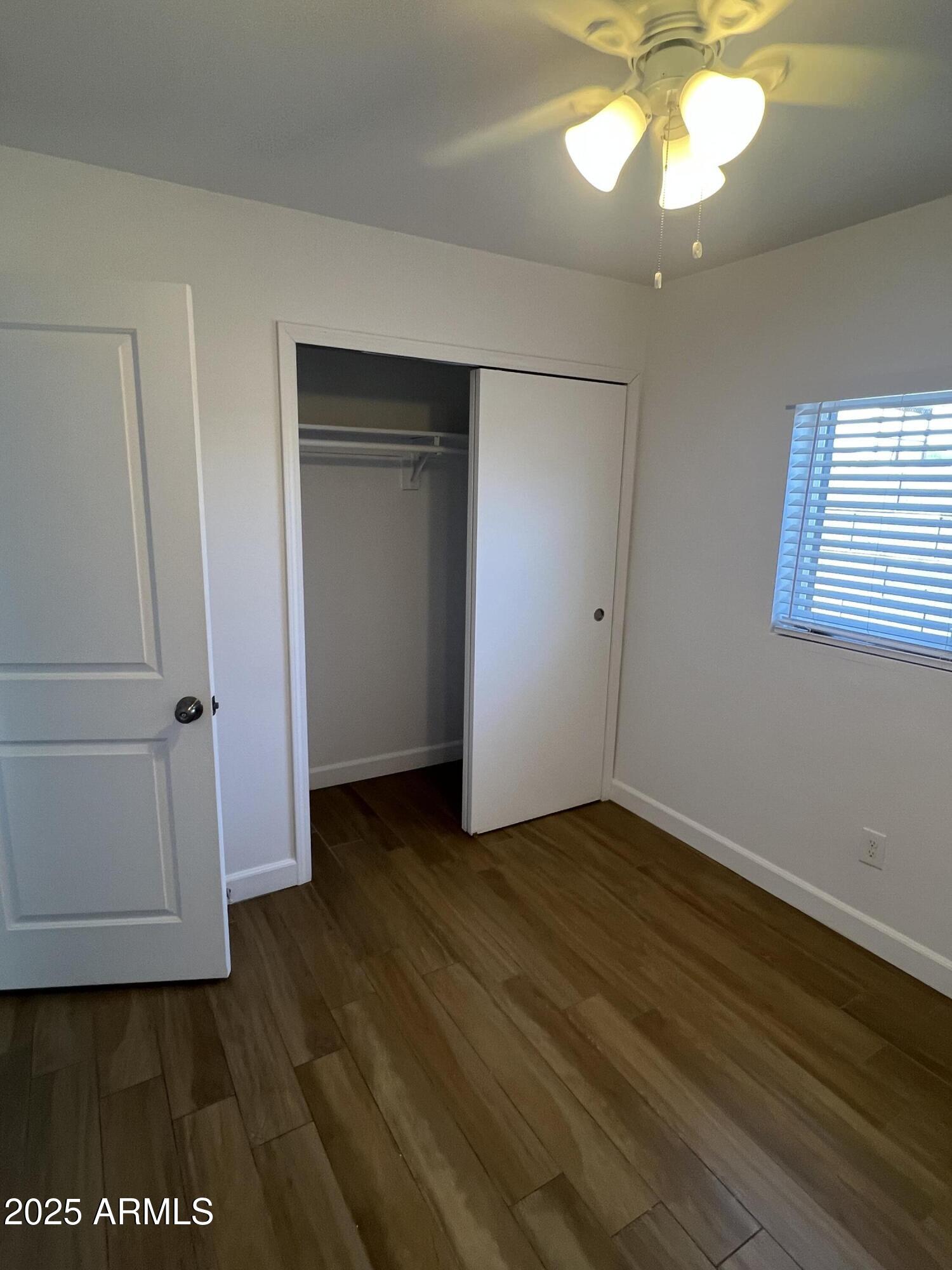 444 South Delaware Street Chandler, AZ 85225 - Photo 13 of 19 an empty room with wooden floor closet and windows
