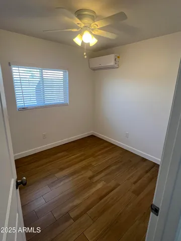 a view of a room with wooden floor and fan
