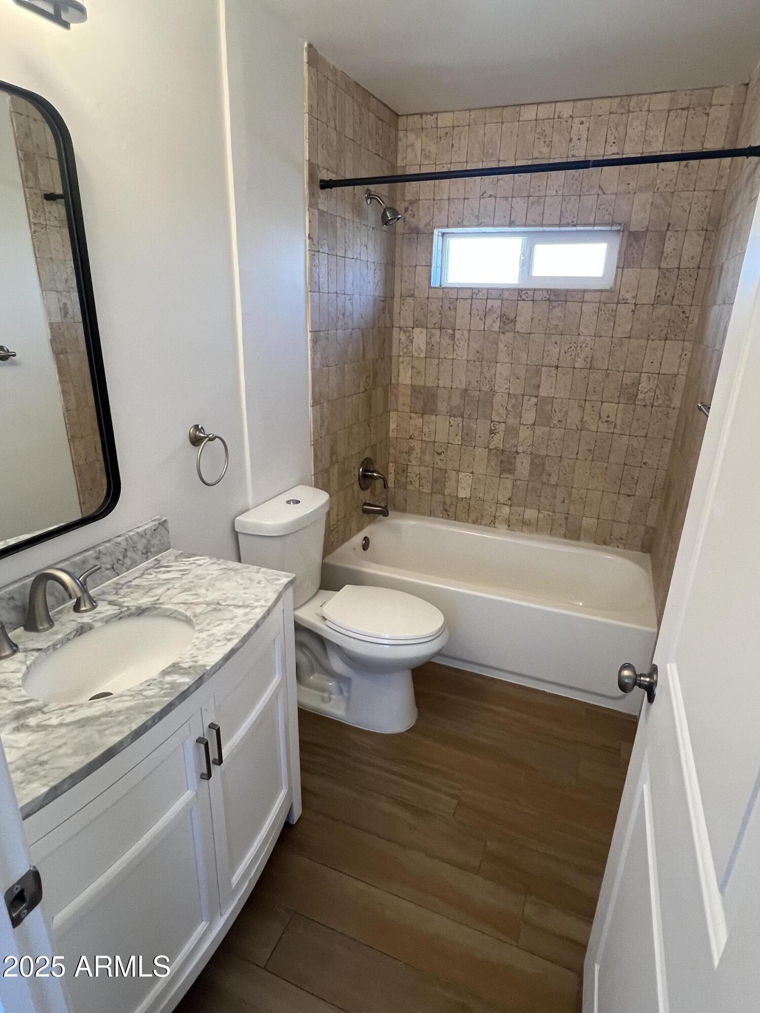 444 South Delaware Street Chandler, AZ 85225 - Photo 15 of 19 a bathroom with a granite countertop sink a toilet a mirror and shower