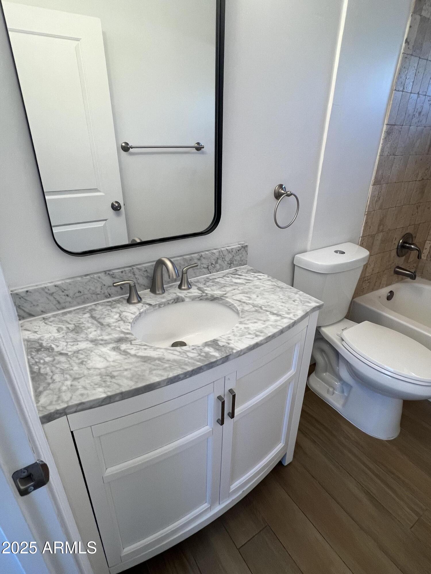444 South Delaware Street Chandler, AZ 85225 - Photo 16 of 19 a bathroom with a granite countertop toilet sink and mirror