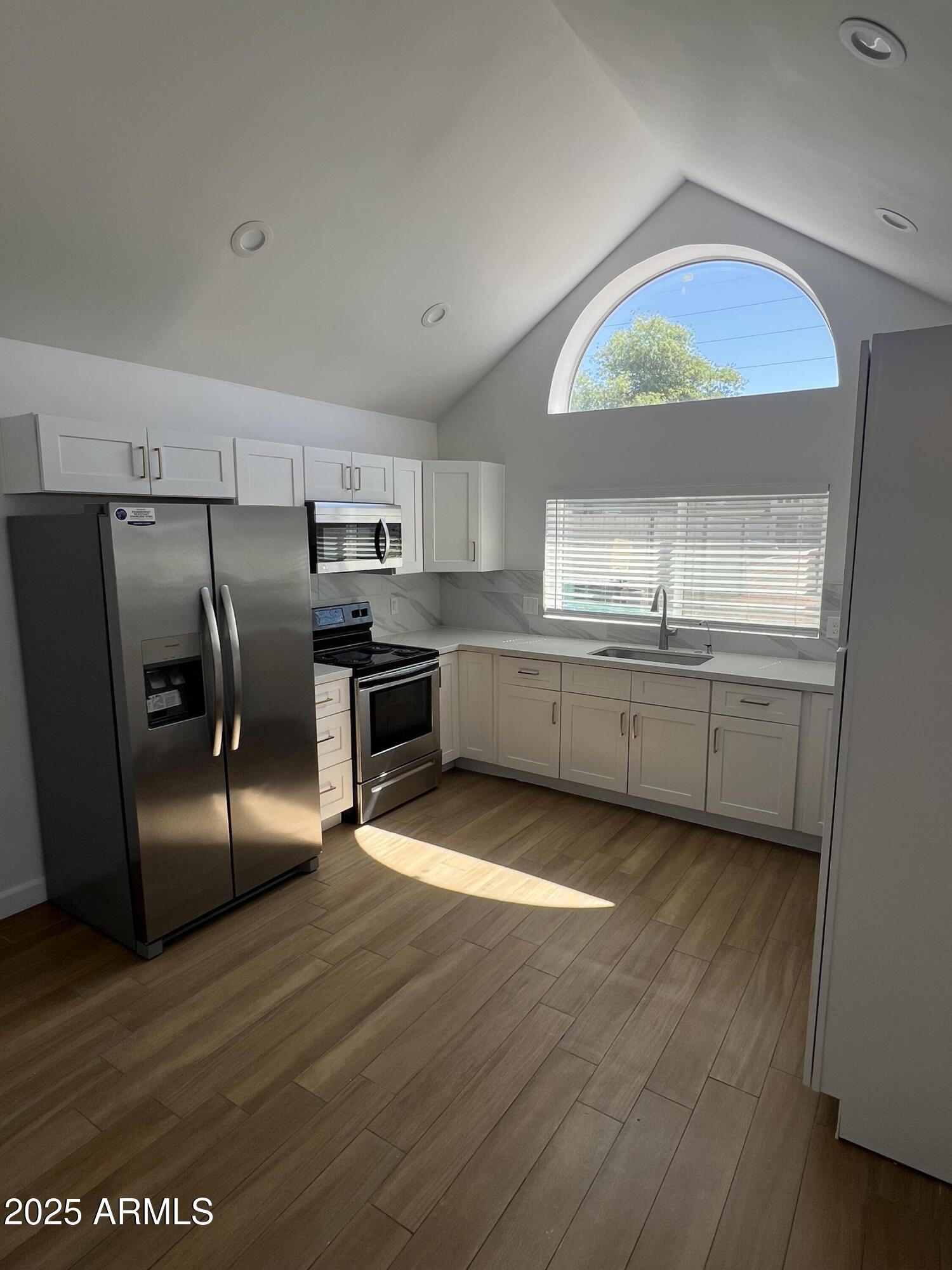 444 South Delaware Street Chandler, AZ 85225 - Photo 2 of 19 a kitchen with stainless steel appliances granite countertop a refrigerator a sink a stove and island