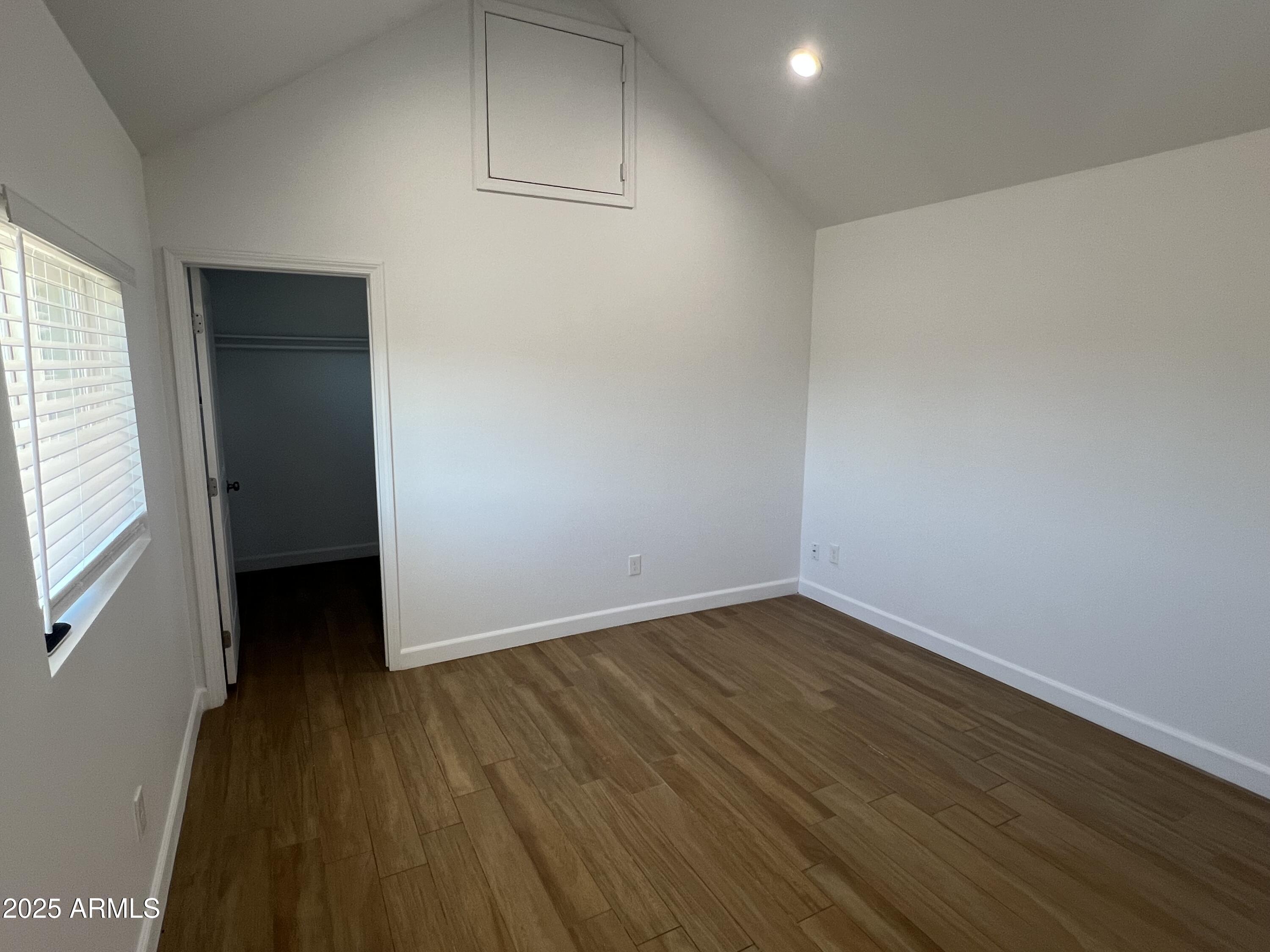 444 South Delaware Street Chandler, AZ 85225 - Photo 8 of 19 a view of an empty room with wooden floor and a window