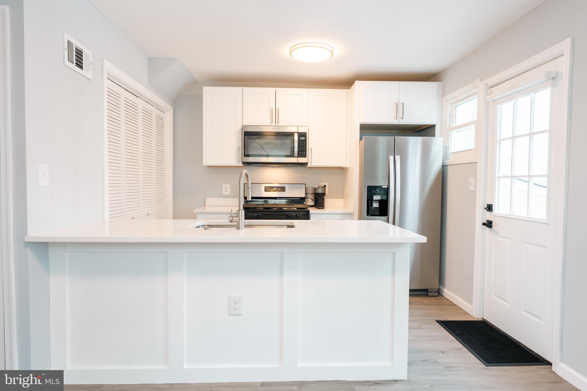 3410 Embry Street Silver Spring, MD 20902 - Photo 6 of 28 a kitchen with a refrigerator a sink and a window
