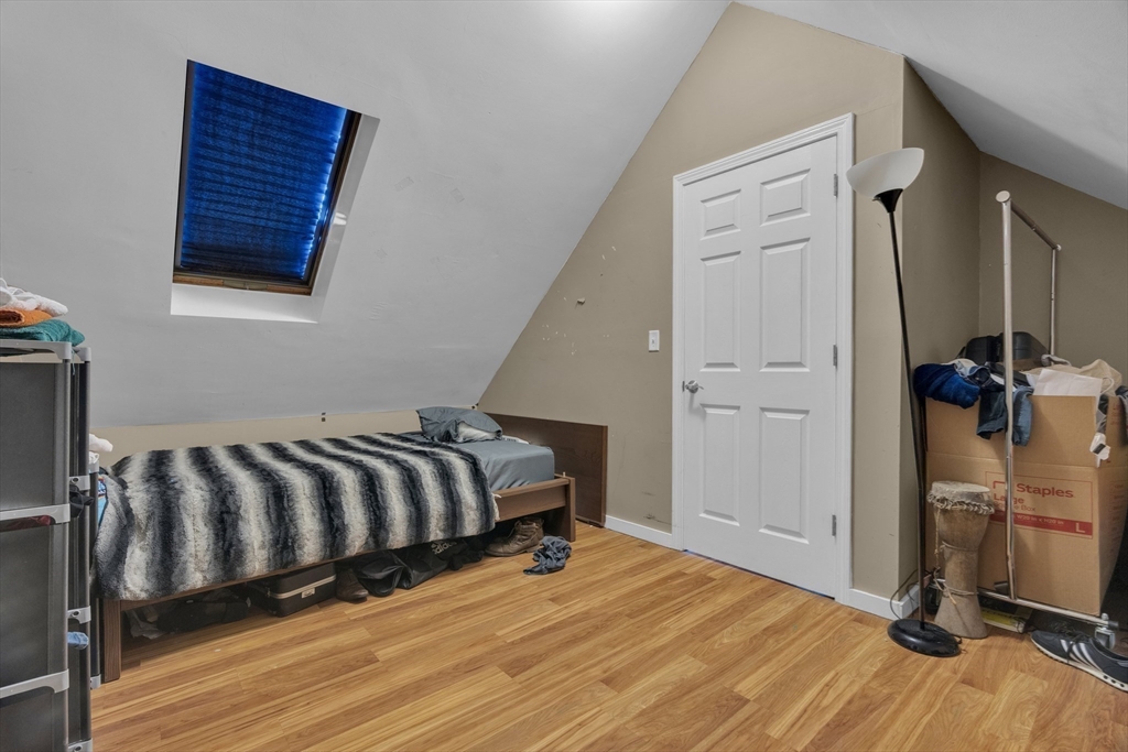 5 Sachem Street, Unit 3 Boston, MA 02120 - Photo 11 of 22 a bedroom with a bed and wooden floor
