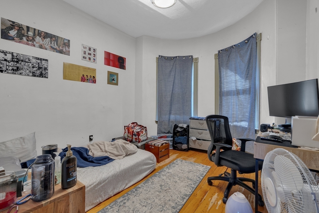 5 Sachem Street, Unit 3 Boston, MA 02120 - Photo 12 of 22 a bedroom with furniture and a flat screen tv