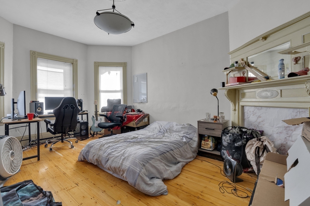 5 Sachem Street, Unit 3 Boston, MA 02120 - Photo 13 of 22 a bed room with two beds and a chair
