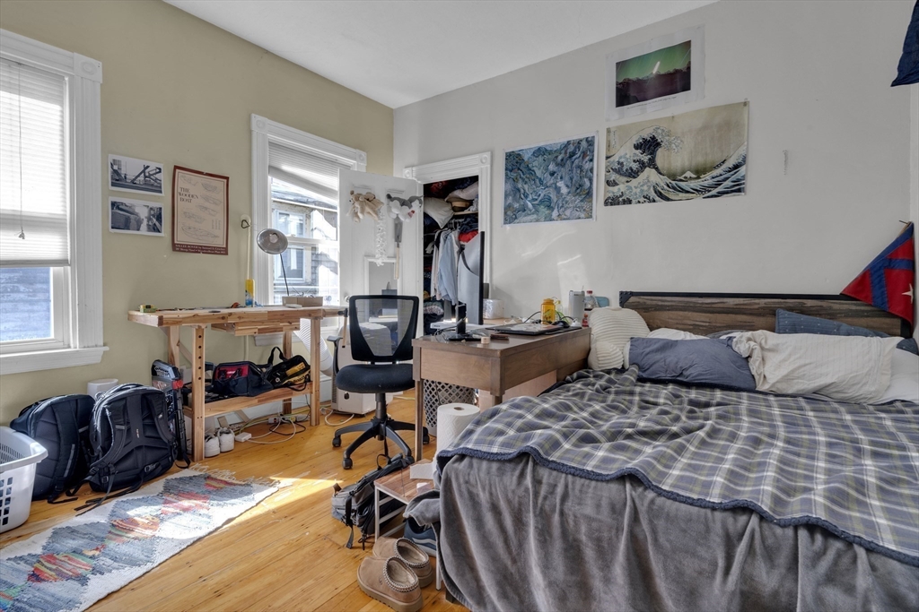 5 Sachem Street, Unit 3 Boston, MA 02120 - Photo 14 of 22 a bedroom with a bed a table and chair