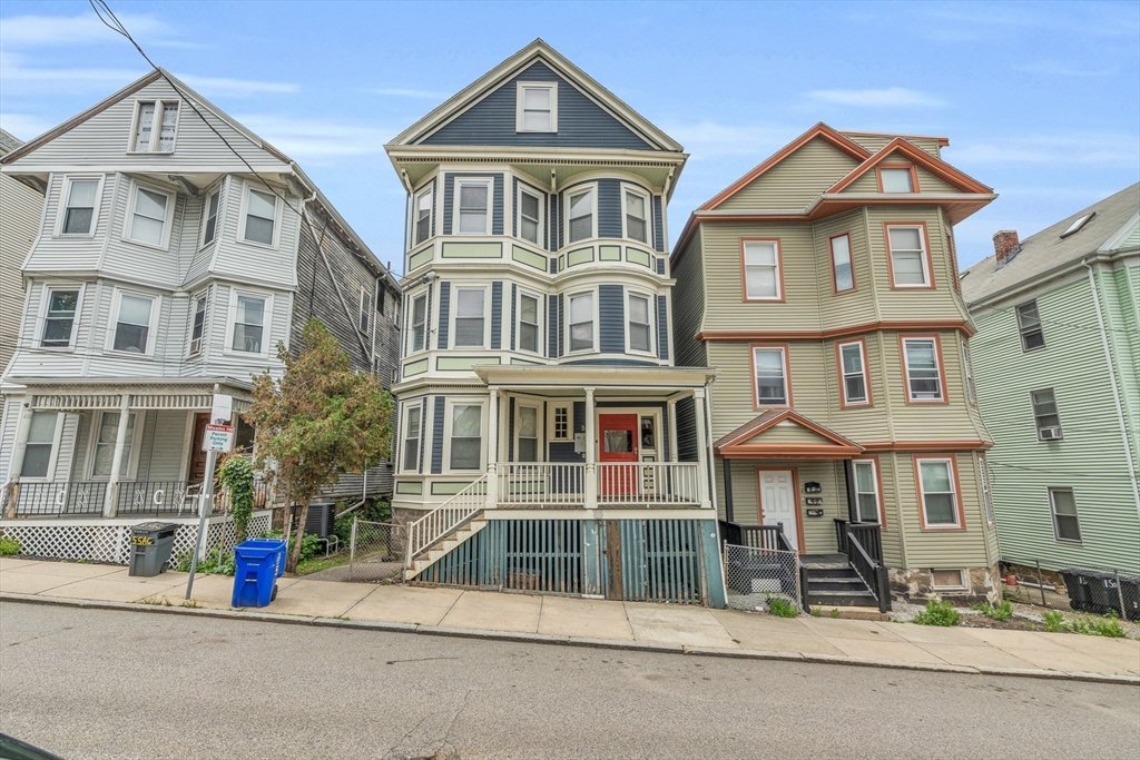 5 Sachem Street, Unit 3 Boston, MA 02120 - Photo 19 of 22 a front view of a residential apartment building with a yard
