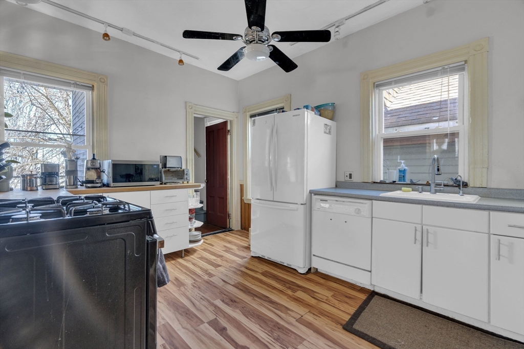 5 Sachem Street, Unit 3 Boston, MA 02120 - Photo 3 of 22 a kitchen with kitchen island a counter top space a sink and stainless steel appliances