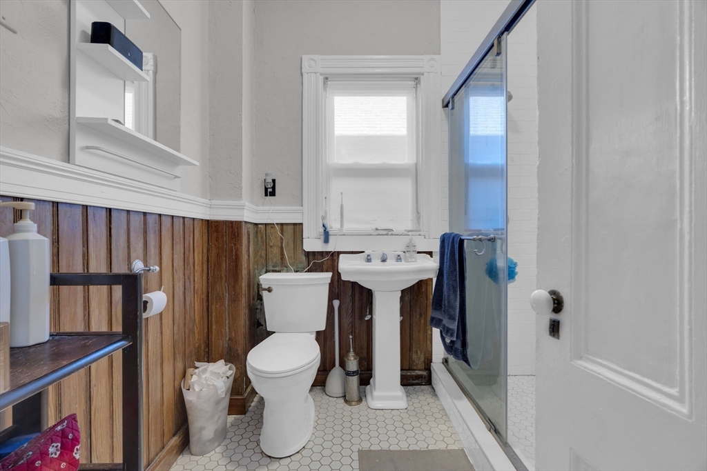 5 Sachem Street, Unit 3 Boston, MA 02120 - Photo 6 of 22 a bathroom with a toilet a sink and a window