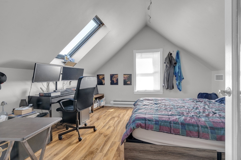 5 Sachem Street, Unit 3 Boston, MA 02120 - Photo 10 of 22 a bedroom with a bed and wooden floor