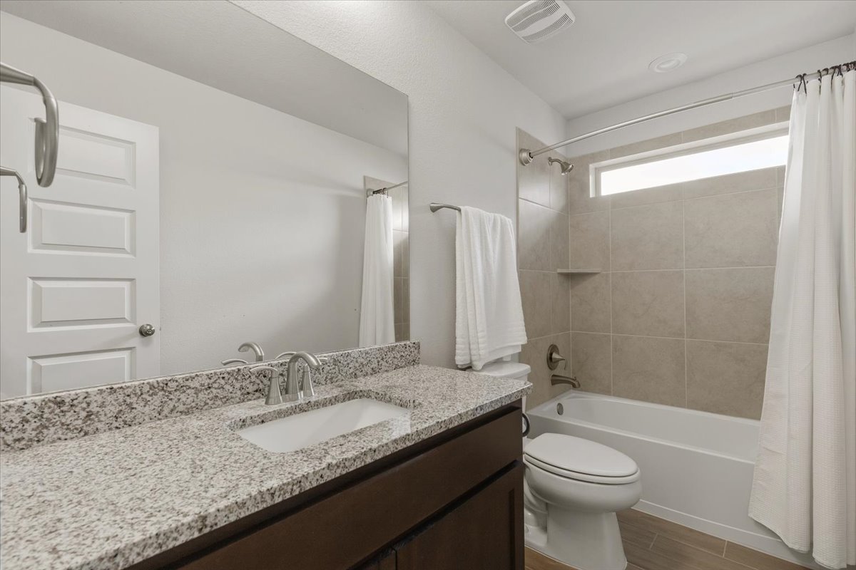 366 Cold Riv Run Kyle, TX 78640 - Photo 19 of 31 Bathroom with a single vanity, granite countertop, and undermount sink