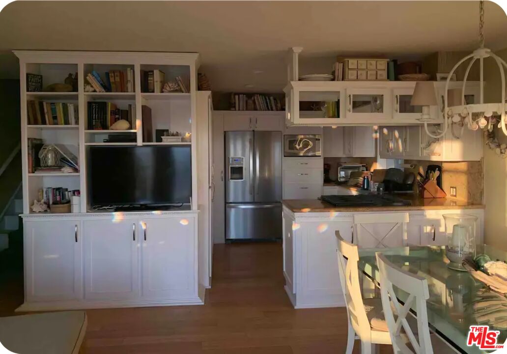 73 A Surfside Avenue Surfside, CA 90743 - Photo 5 of 18 a kitchen with a refrigerator and a stove top oven