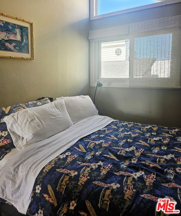 73 A Surfside Avenue Surfside, CA 90743 - Photo 10 of 18 a bed sitting in a bedroom next to a window