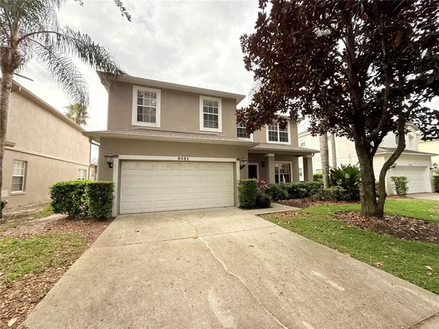 a front view of a house with a yard and garage