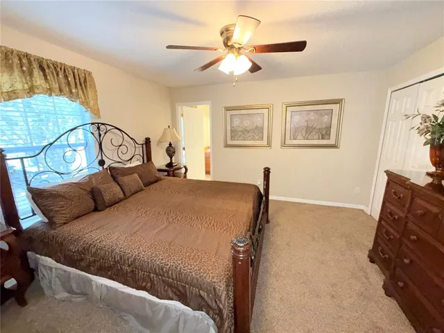 a bedroom with a bed dresser and a window