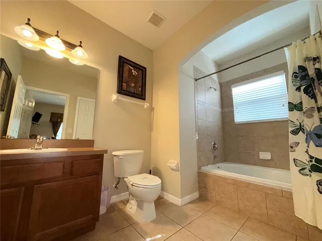 a bathroom with a toilet a sink and bathtub