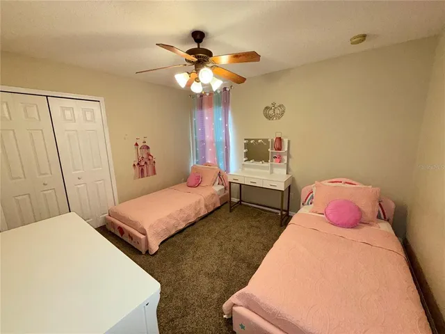 a bedroom with a bed chandelier and a window