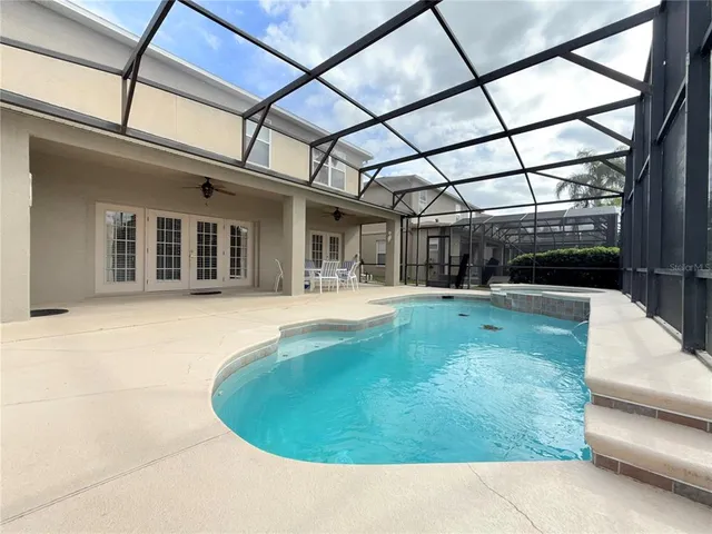 a view of a swimming pool with a outdoor seating