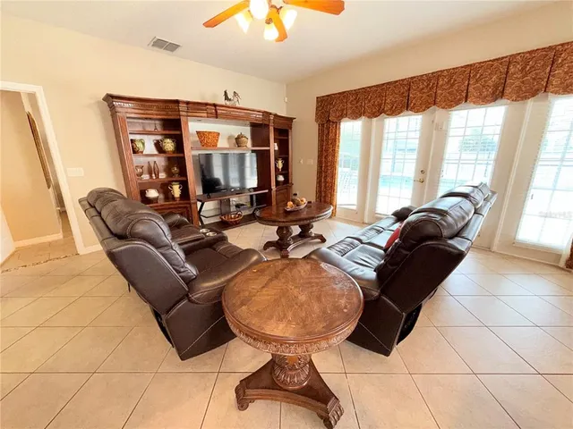 a living room with furniture a window and a chandelier