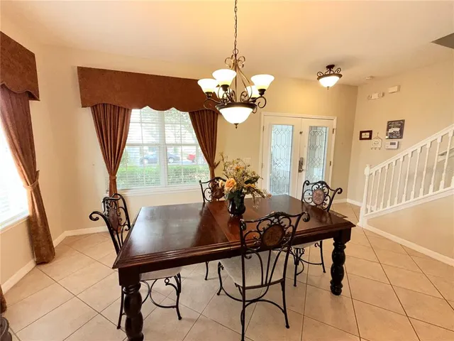 a view of a dining room with furniture and a chandelier