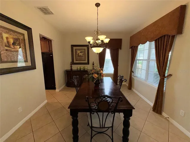 a dining room with furniture and window