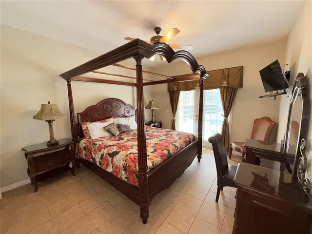 a bedroom with a bed a dresser and the view of the mirror