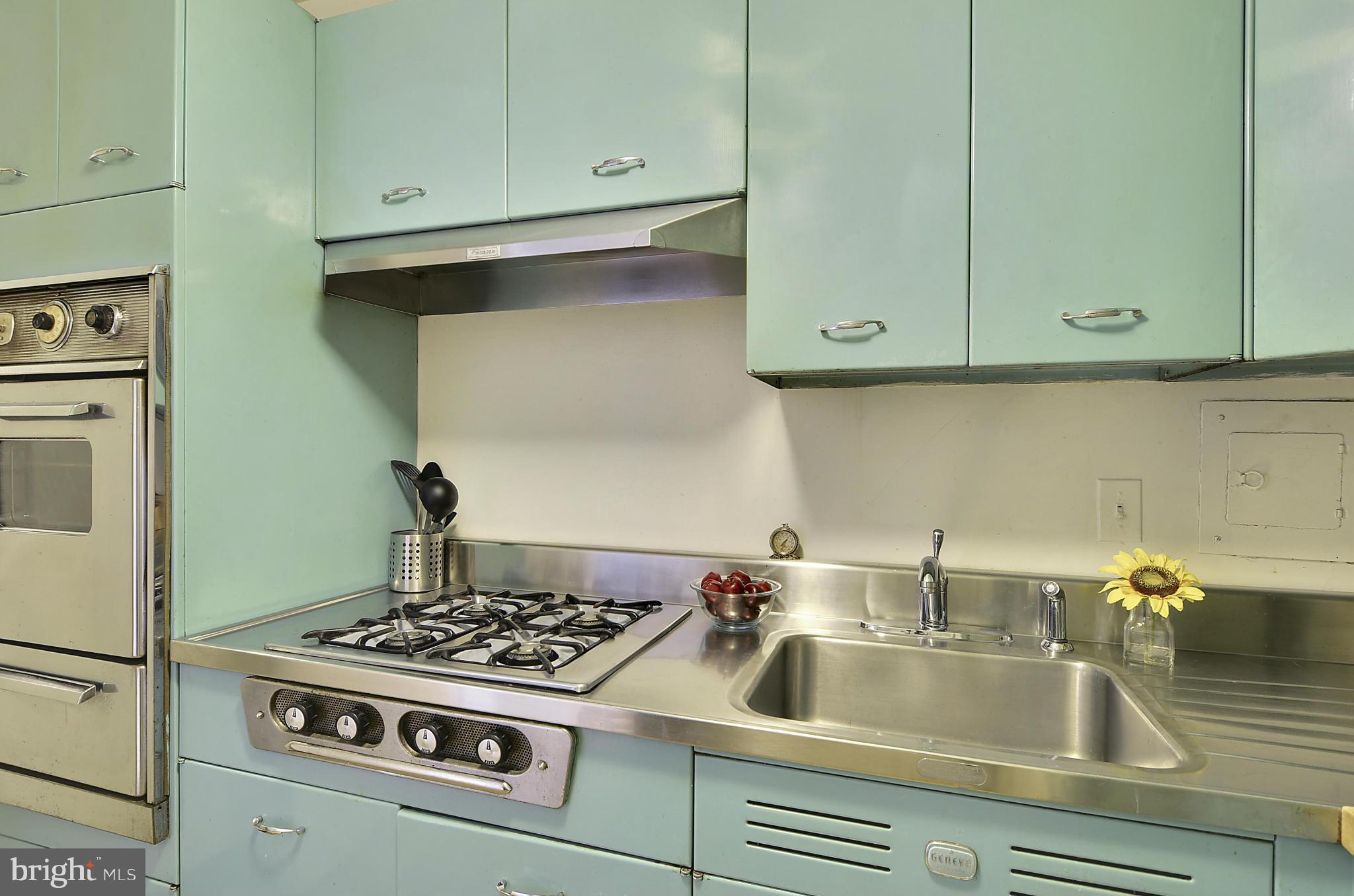 2401 H Street Northwest, Unit 309 Washington, DC 20037 - Photo 11 of 28 a white stove top oven sitting inside of a kitchen