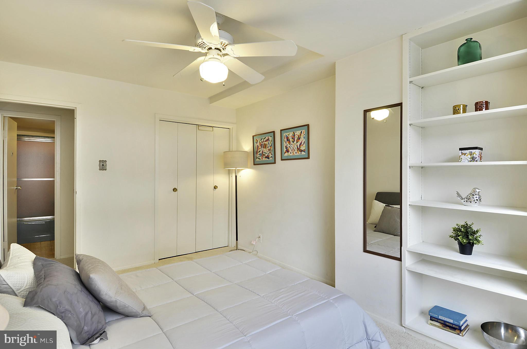 2401 H Street Northwest, Unit 309 Washington, DC 20037 - Photo 12 of 28 a spacious bedroom with a bed and cabinets