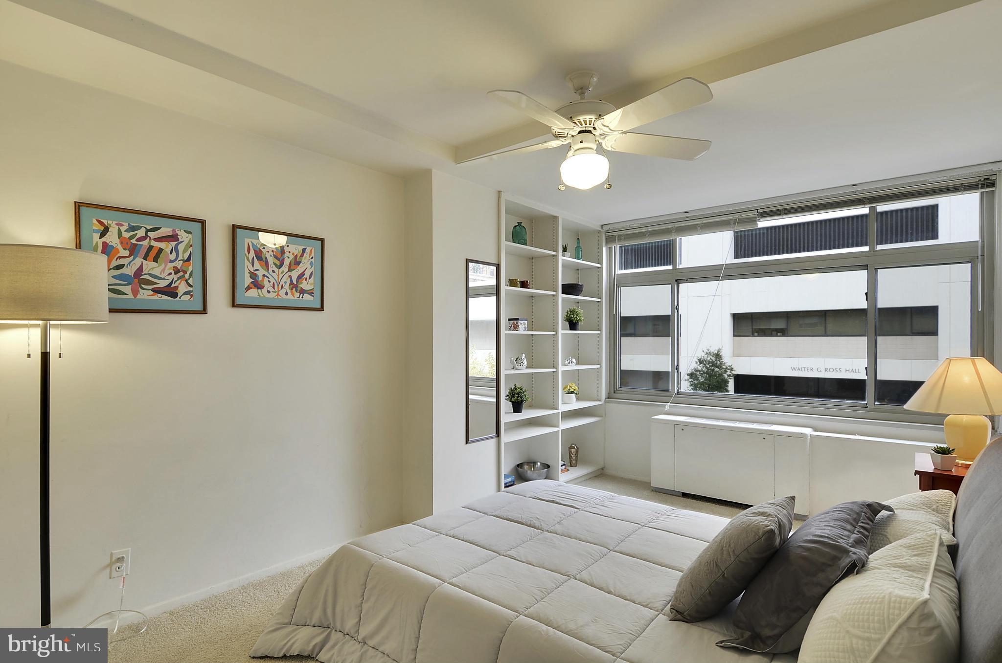 2401 H Street Northwest, Unit 309 Washington, DC 20037 - Photo 14 of 28 a bedroom with a bed and a chandelier