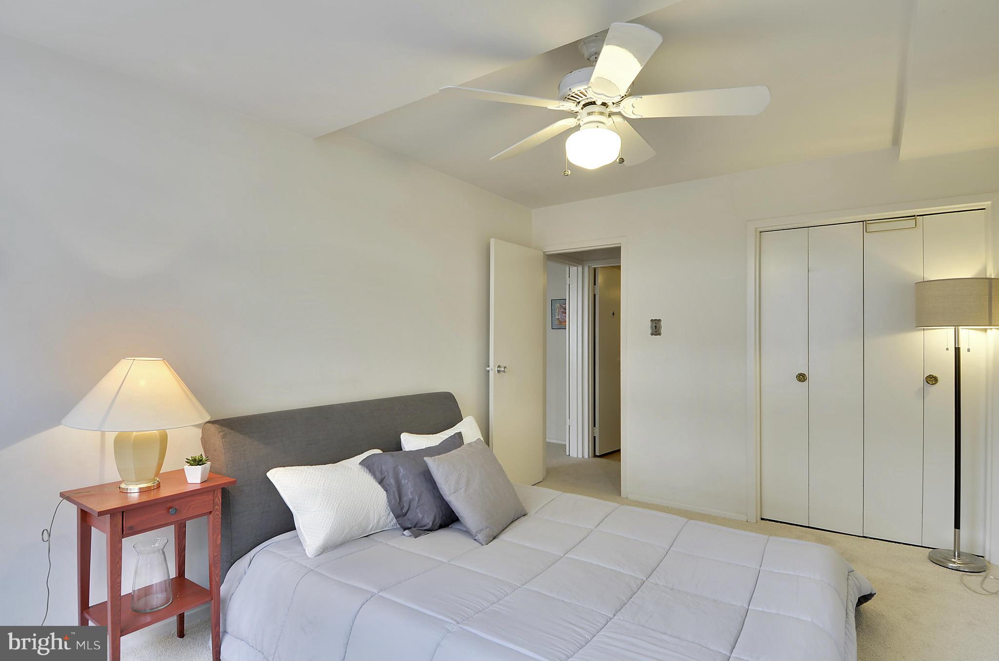 2401 H Street Northwest, Unit 309 Washington, DC 20037 - Photo 15 of 28 a bedroom with a bed and a chandelier