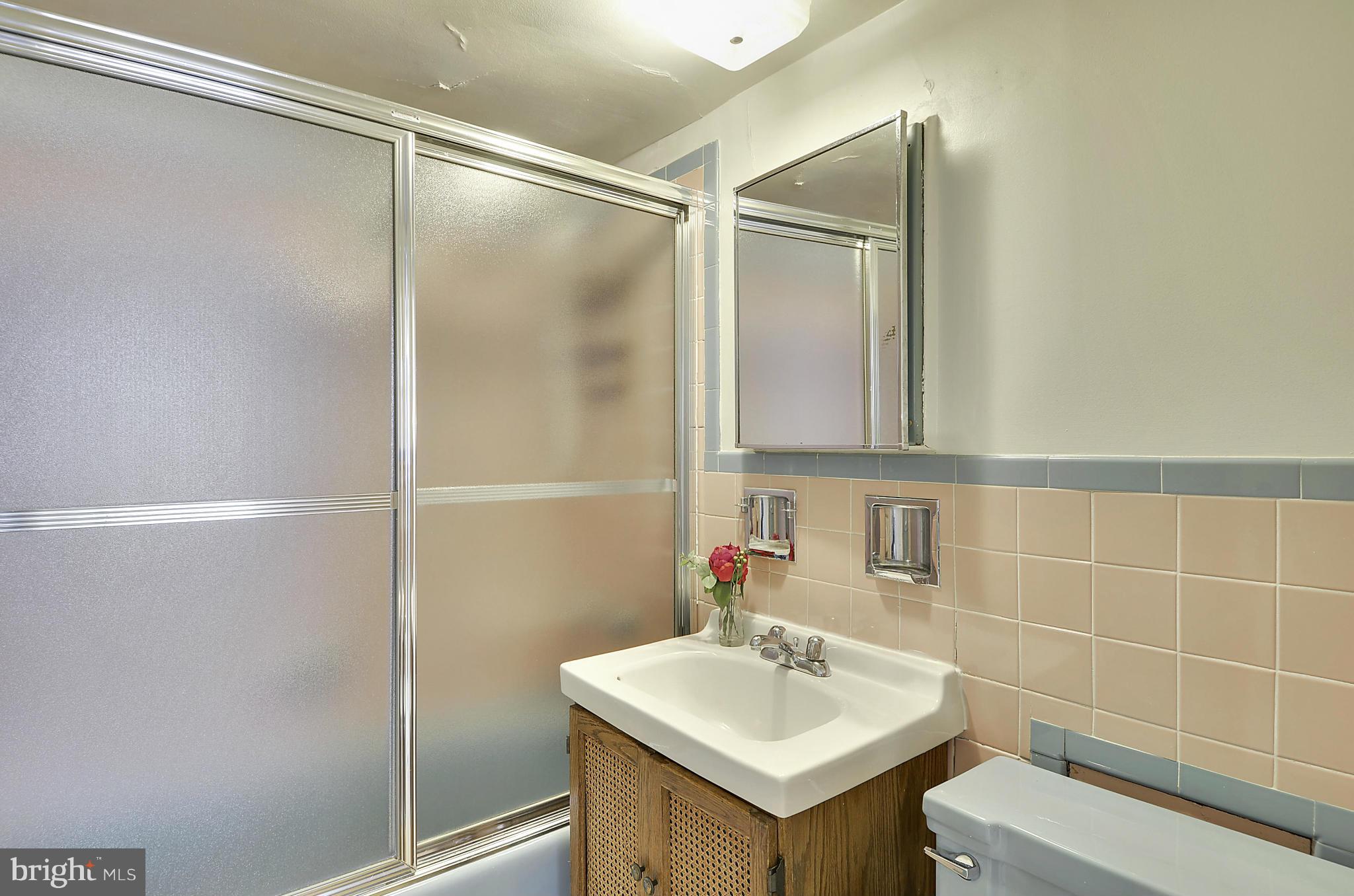 2401 H Street Northwest, Unit 309 Washington, DC 20037 - Photo 16 of 28 a bathroom with a sink a toilet and shower