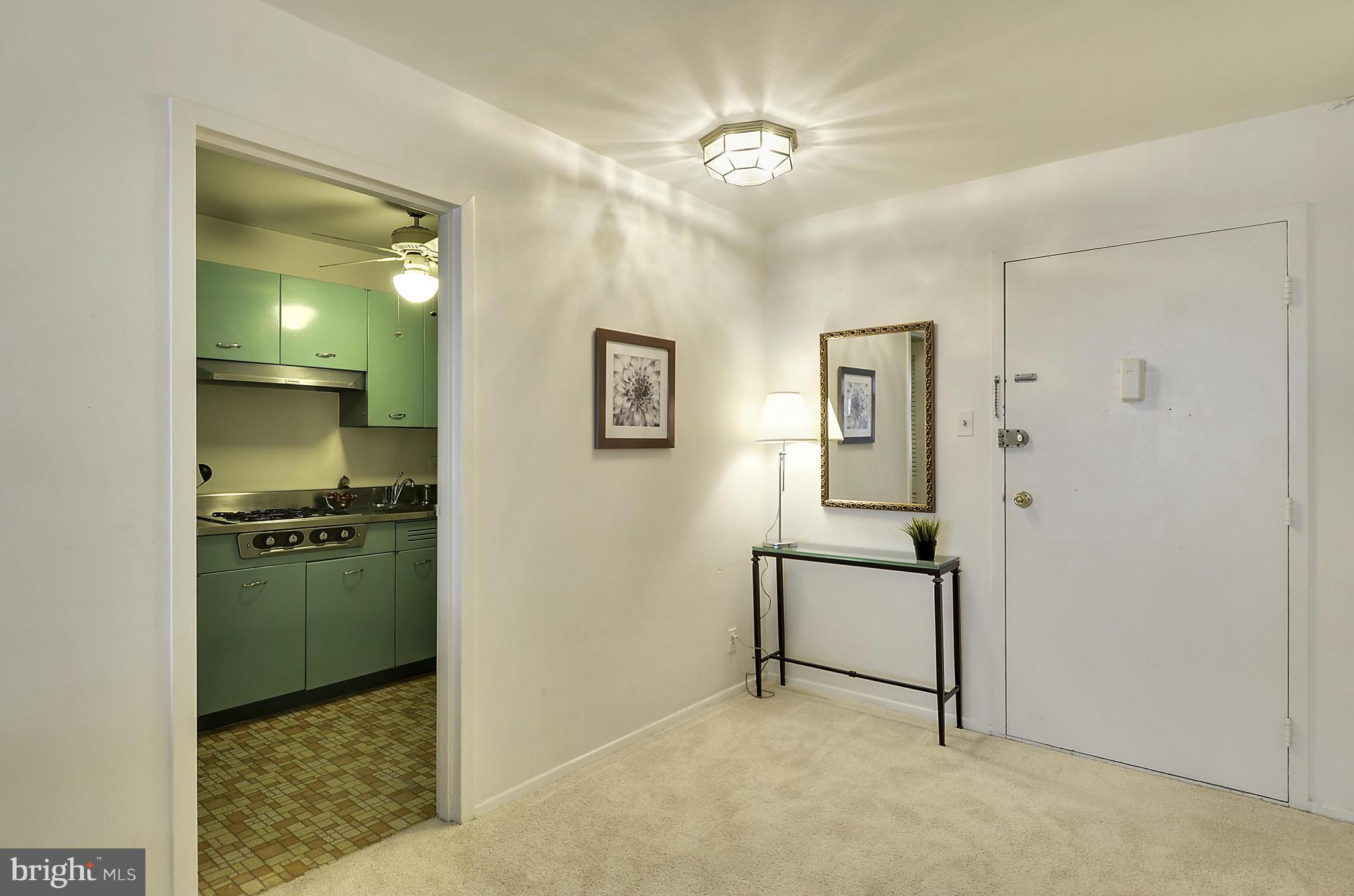 2401 H Street Northwest, Unit 309 Washington, DC 20037 - Photo 5 of 28 a view of a hallway with a kitchen