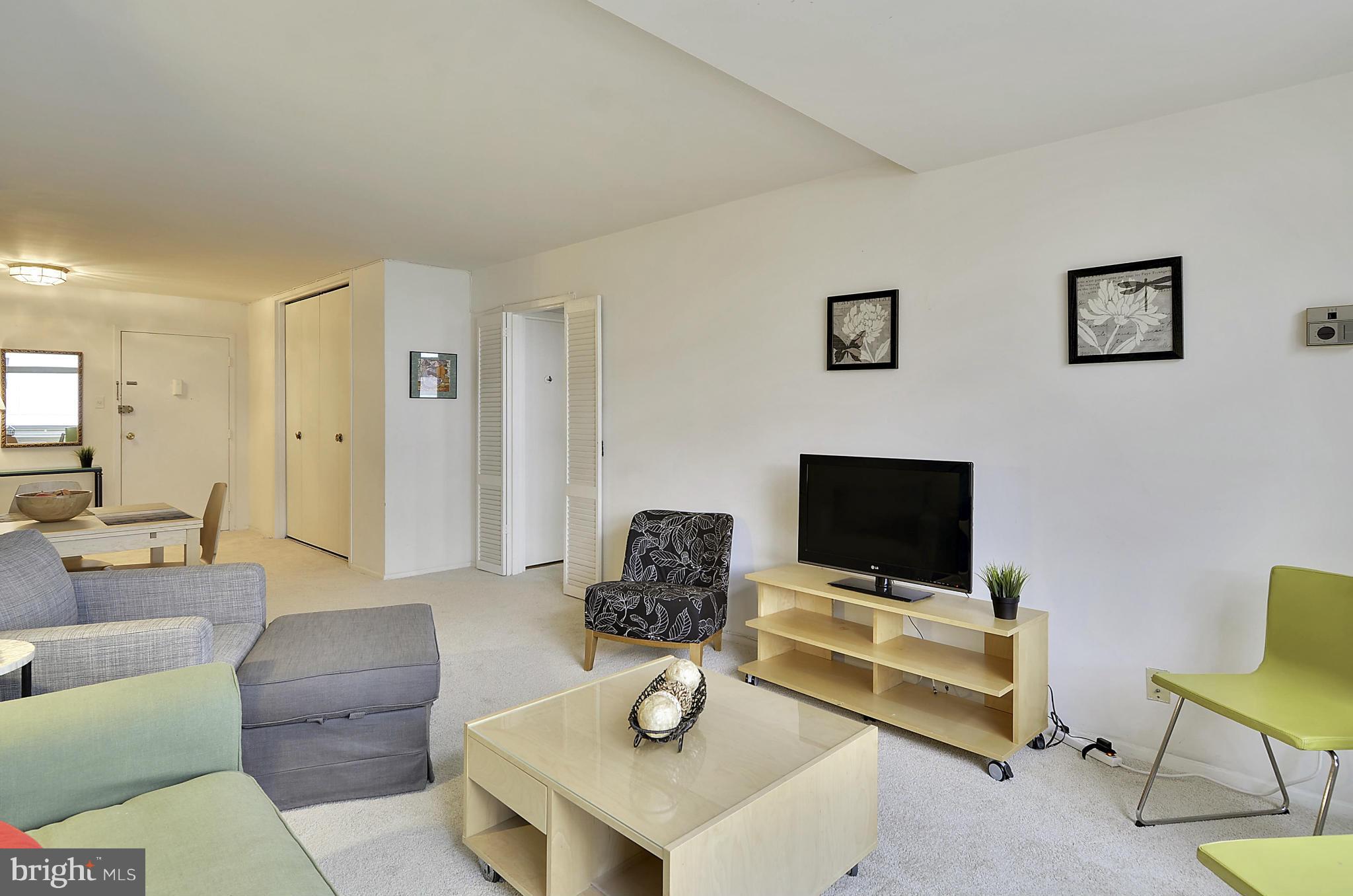 2401 H Street Northwest, Unit 309 Washington, DC 20037 - Photo 9 of 28 a living room with furniture and a flat screen tv