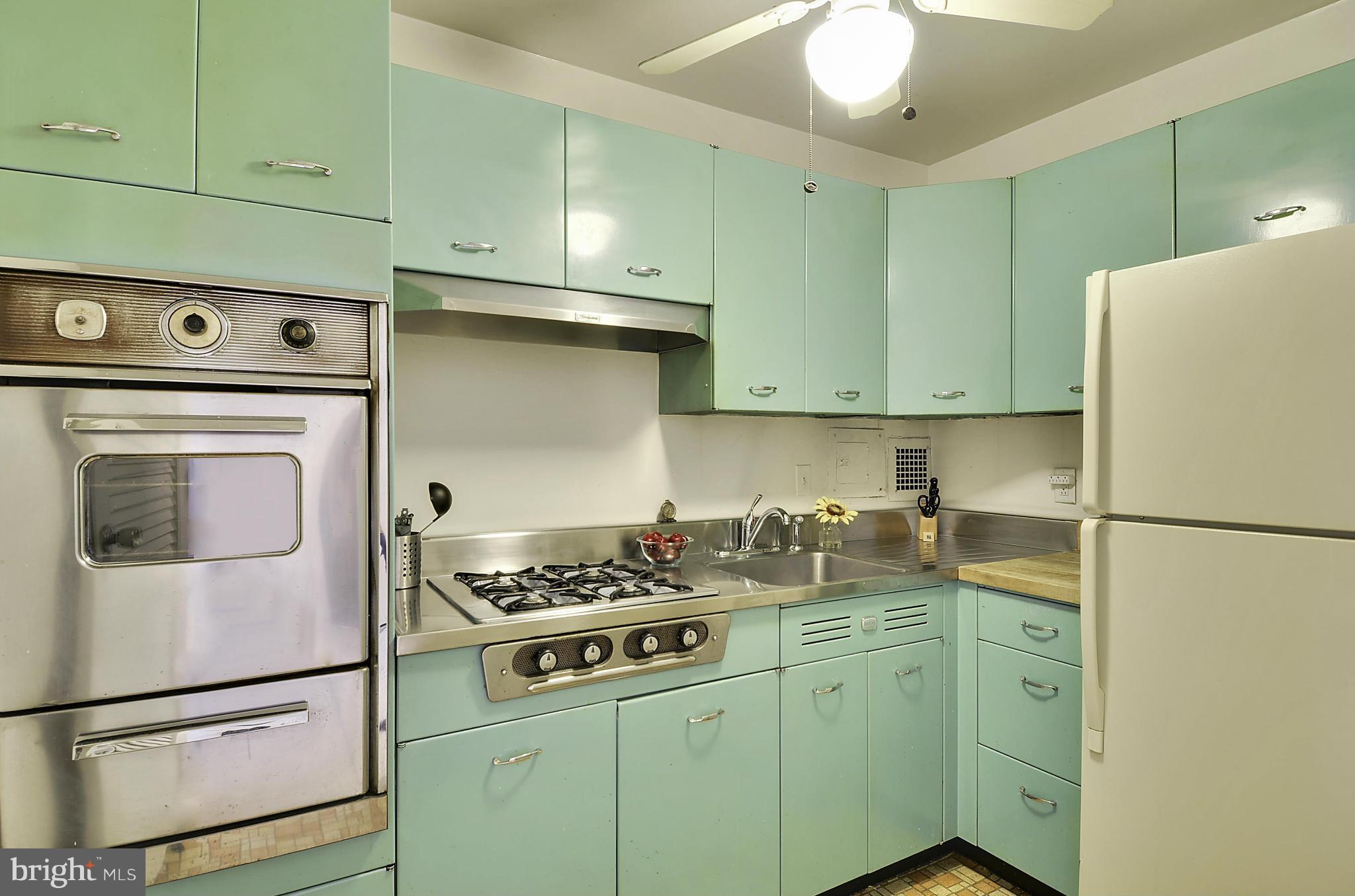 2401 H Street Northwest, Unit 309 Washington, DC 20037 - Photo 10 of 28 a kitchen with cabinets appliances and a counter space