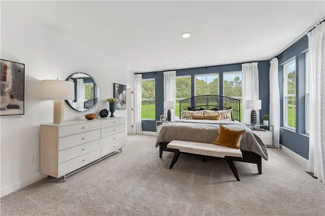 a bed room with a bed and a large window