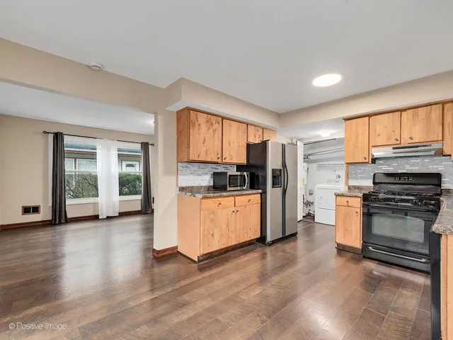a kitchen with stainless steel appliances granite countertop a stove and a refrigerator