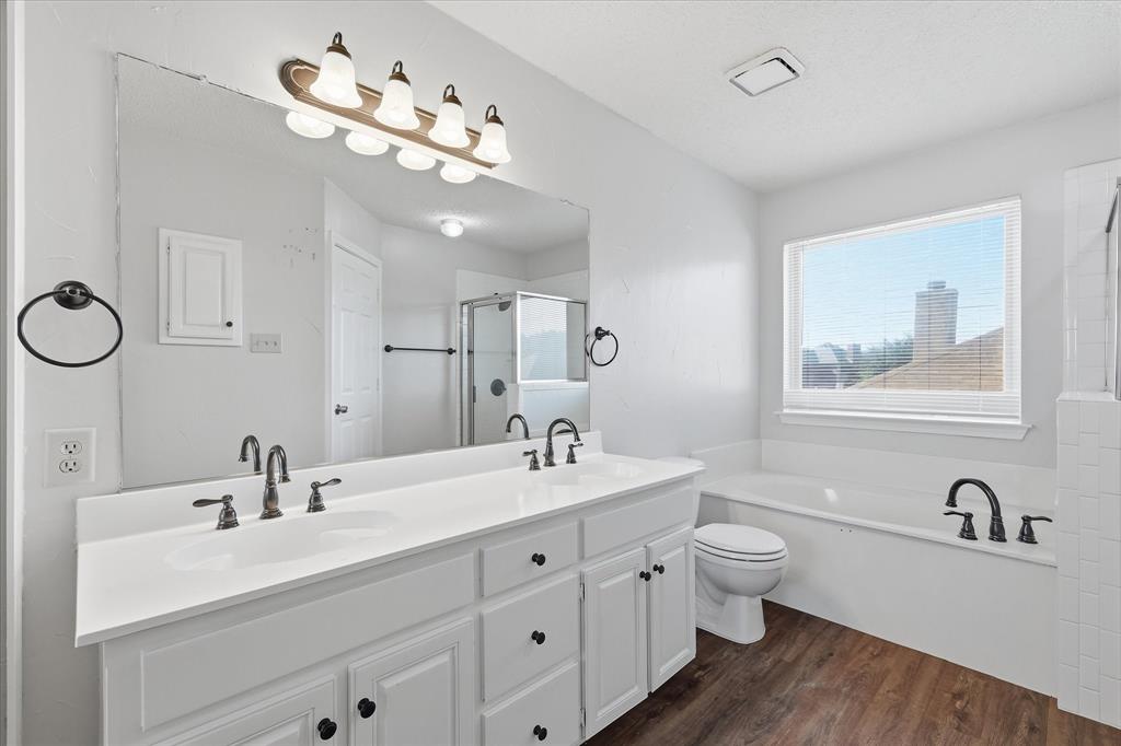 318 Lodge Road Coppell, TX 75019 - Photo 23 of 35 The generous primary suite offers a peaceful, light-filled atmosphere with an adjoining bath and flexible room for furnishings.