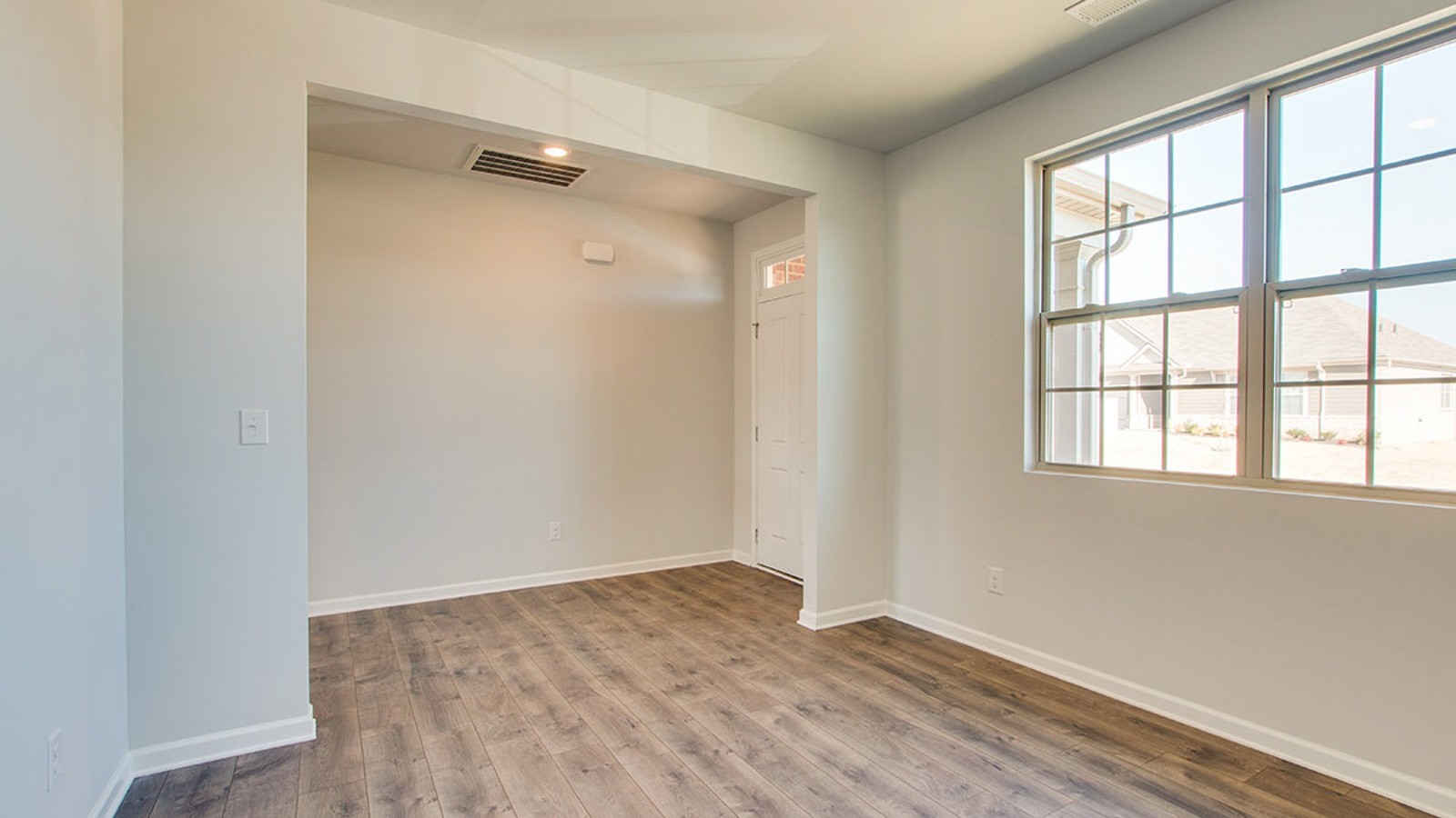 5448 Mason Way Cookeville, TN 38506 - Photo 4 of 30 an empty room with wooden floor and windows