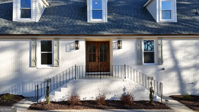 a view of empty room with wooden floor and fireplace