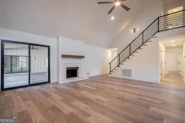 a kitchen with a stove a sink a refrigerator and chairs