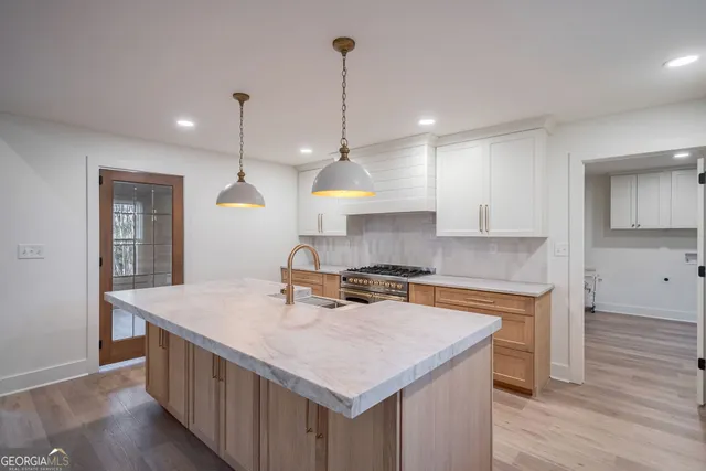 a kitchen with white cabinets and stainless steel appliances