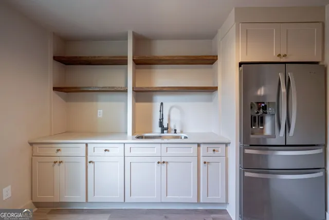 a bathroom with a tub sink and mirror