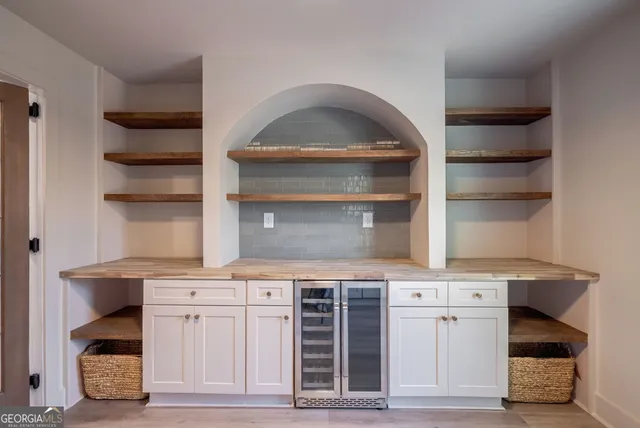 a bathroom with a tub a sink and a mirror