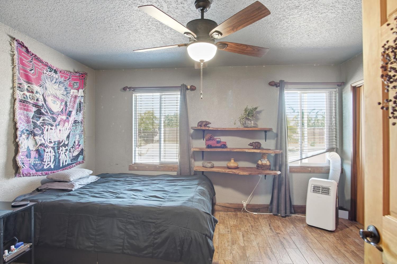 5200 North Gratton Road Denair, CA 95316 - Photo 19 of 40 a bedroom with a bed and wooden floor
